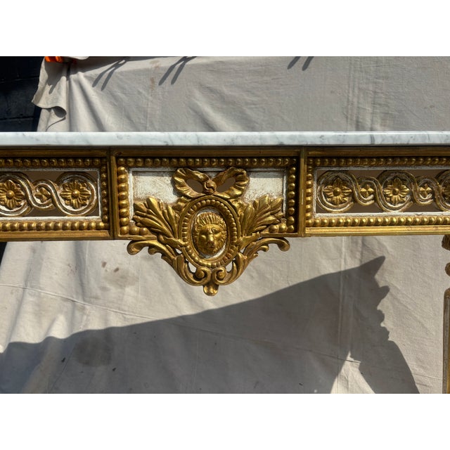 Crafted with meticulous attention to detail, the console features a finely carved wooden frame, adorned with classical...