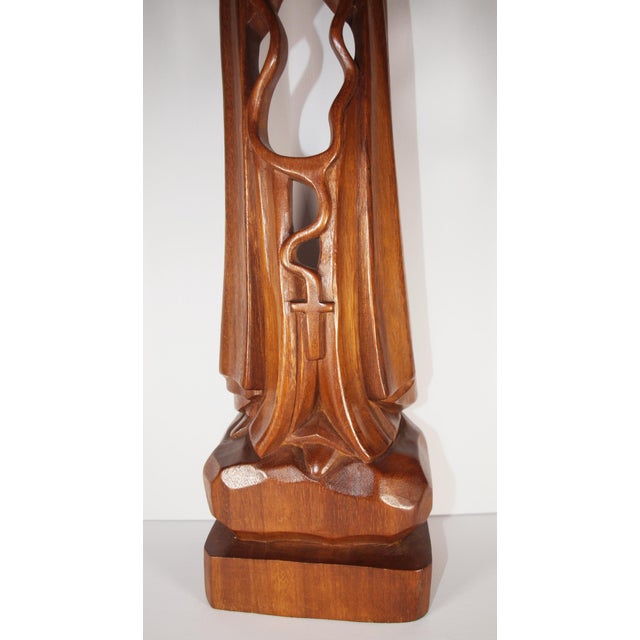 A hand carved abstract statue of the Virgin Mary/Madonna. Wood is solid piece of walnut and measures 22” high, 6” wide and...