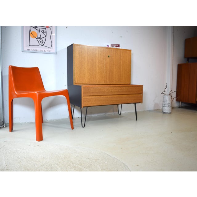 This is a two-part Omnia teak cabinet from Germany. The lower section consists of a spacious drawer, and the upper section...