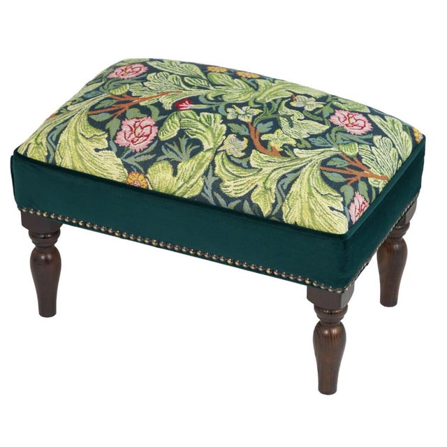 Meticulously handcrafted in the United Kingdom, this upholstered stool boasts classic studding and hand-polished solid...