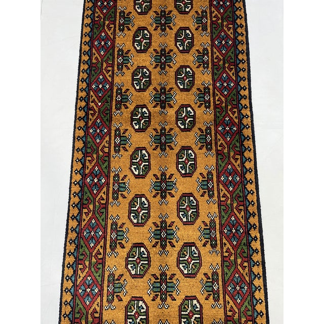 Add warmth and intricate pattern to your hallway with this terracotta brown wool runner featuring a traditional Turkmen...