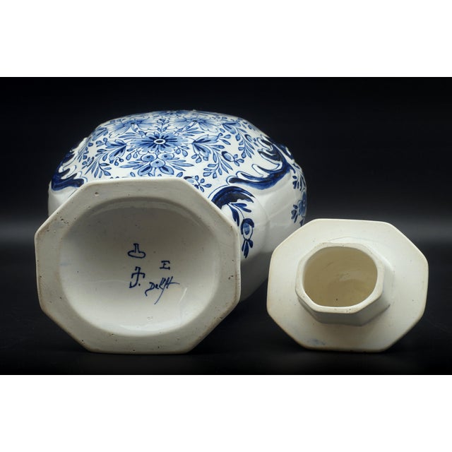 Antique Porceleyne Fles/Royal Delft blue and white balluster vase with a floral pattern and a dog on top of the lid...