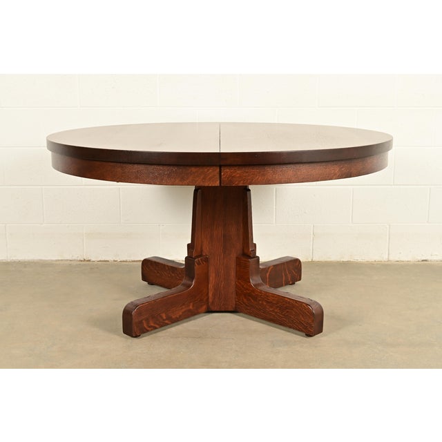 An outstanding antique Mission or Arts & Crafts period quarter sawn oak pedestal extension dining table In the manner of...