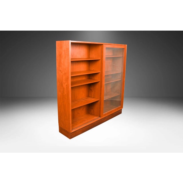 An exceptional teak tall double wide bookcase/display cabinet by Poul Hundevad from Denmark. Featuring dual, original,...