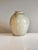 Handcrafted and signed studio ceramic vase from 1976, featuring a softly rounded, classic vase shape and a gently...