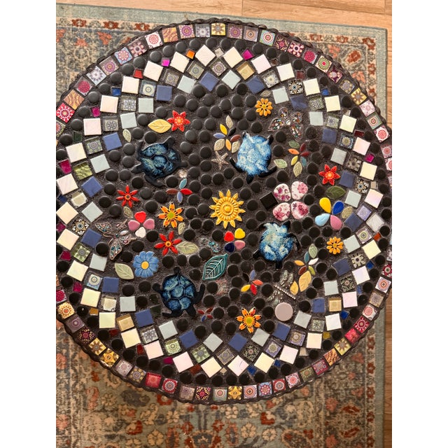 Elevate your home or garden with this exquisite handcrafted mosaic table, a true labor of love where each individual piece...