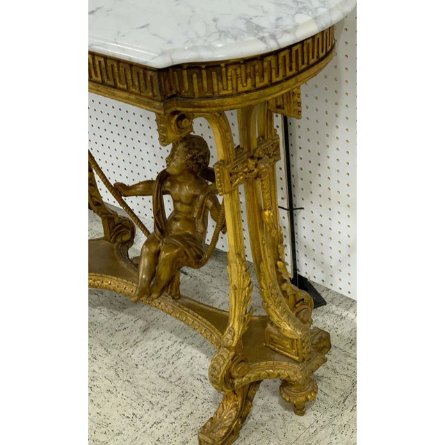 Exquisite French giltwood swinging putto marble-top table/ Ferner, with beveled Carrara marble top revealing a removable...