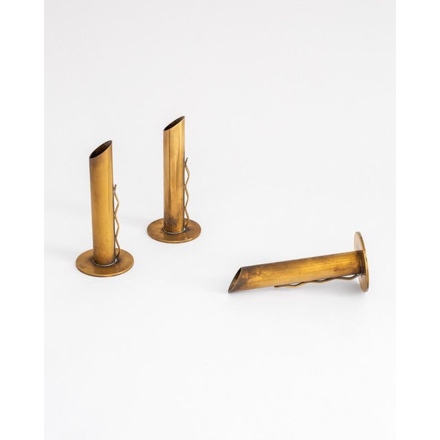 An elegant set of three brass vases, most likely produced by the iconic Swedish maker Ystad-Metall, 1950s–60s. Each piece...