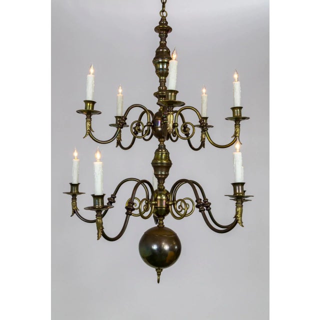 A spacious, Dutch Baroque style, 10-arm, brass chandelier with lovely decorative scroll work and acanthus leaf accents...