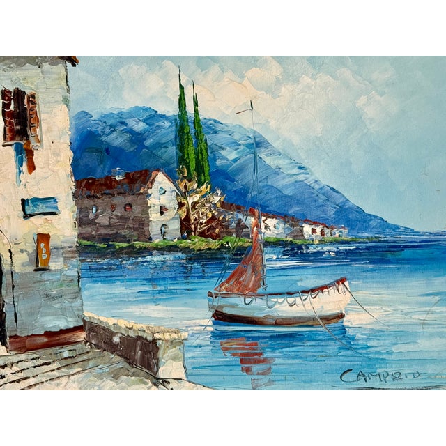 An original vintage oil on canvas by Giovanni Camprio, this signed and framed painting depicts a sailboat at the water’s...