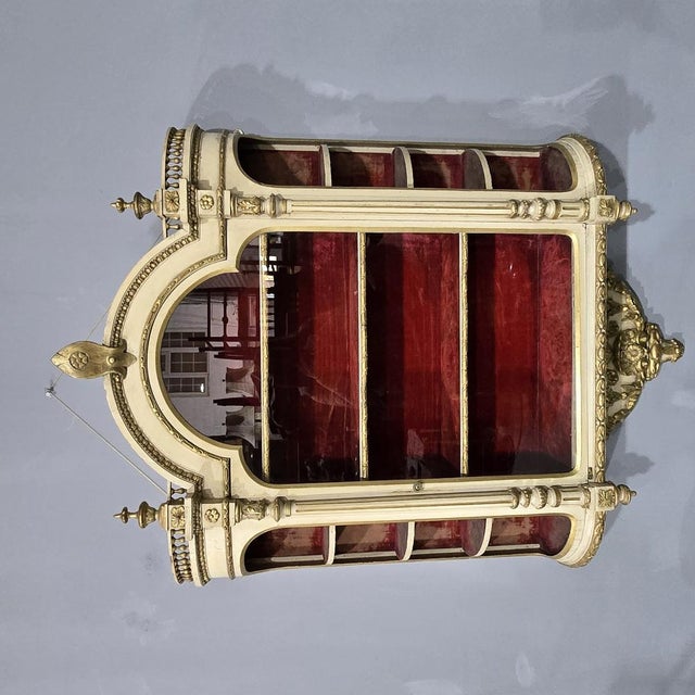 A very rare good Victorian painted and parcel gilt hanging wall vitreen,bowed side shelves and central glazed door with...