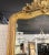 This mirror is an early 19th-century French gilt wood and gesso piece. This type of mirror typically showcases the...