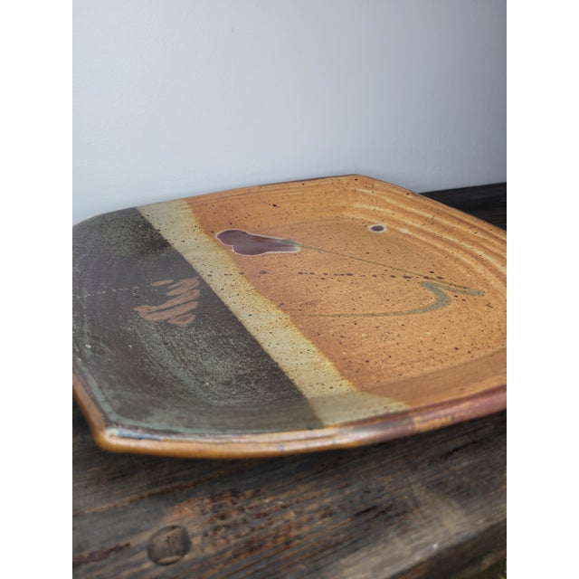A striking and substantial studio pottery platter featuring a modernist, minimalist aesthetic. This piece is crafted from...