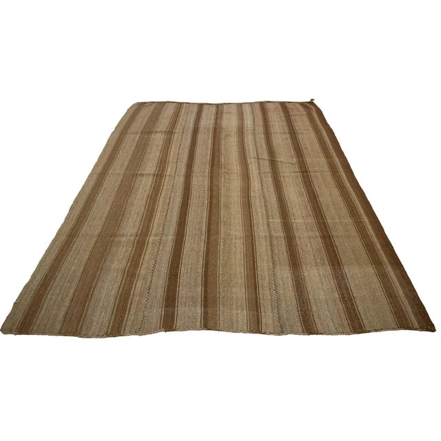 Brown handwoven vintage kilim rug from Kars region of Turkey. Approximately 50-60 years old. In very good condition