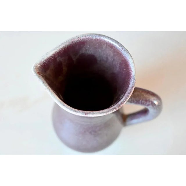 This beautiful pitcher is a production of the Lorraine earthenware of Saint Clément. with its geometric shapes and its...