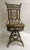 This fanciful Victorian wicker swivel piano chair has all the bells and whistles of the most prestigious American wicker...