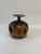 Turned wood vase with a copper and painted accent. Made by Wanderin’ Willy Totara, New Zealand. The model number is A.805.