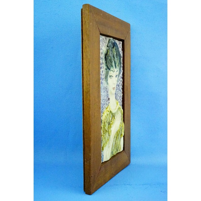 MEASUREMENTS (including stand): Height: 27.5 cm; Width: 17.5 cm; Depth: 1.5 cm Item : Polychrome ceramic sculptural plaque...