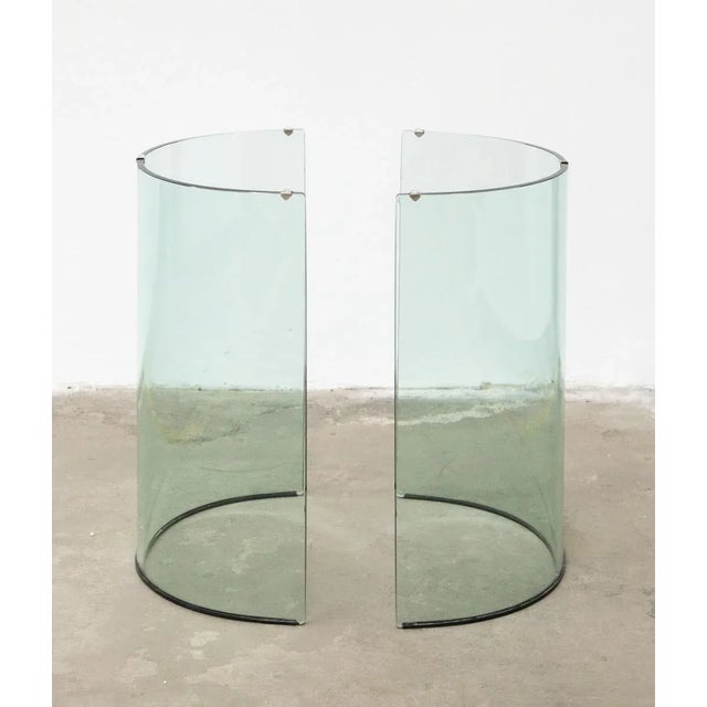 1980s tempered glass table made by Fiam The oval top rests on two supports that can be oriented to converge or repel each...