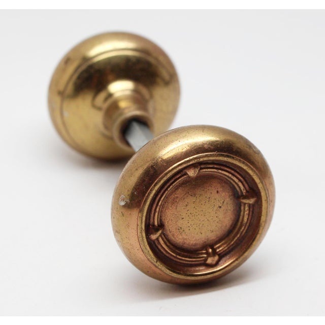 Art Deco style concentric design doorknob made of bronze with a polished finish. The manufacturer and date of creation is...