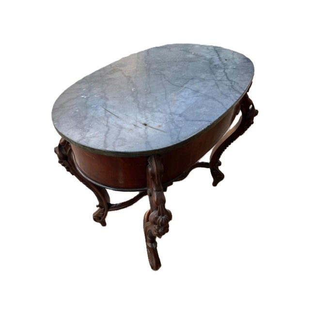Oval wooden table with marble top and Luigi filippo walnut drawer The marble top has some marking and 2 holes as shown in...