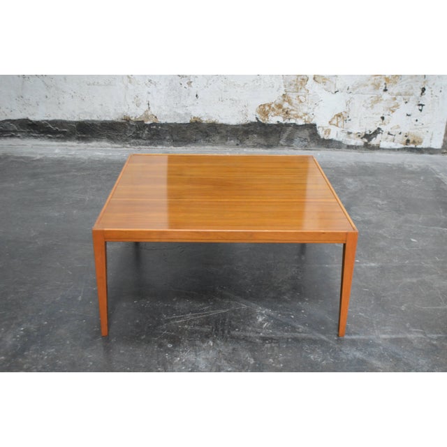 Sleek modern square coffee table with beautiful wood grain and atop tapered legs. Nice large size of 41.25" square.