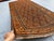 A vintage hand-knotted Baluch rug, worked on a dark aubergine-brown field in madder rust, camel and ivory. The Baluch are...