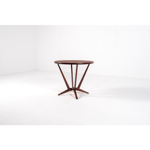 Elegant Danish mid-century side table produced in Denmark, circa 1960s. The table features a richly grained round rosewood...