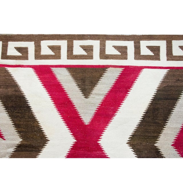 Woven around 1900, this exceptionally rare large-format Navajo rug is a striking example of Indigenous artistry on an...