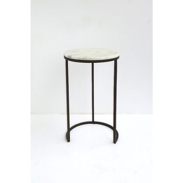 A granite marble and bronzed metal side drinks table. Granite is predominantly white with neutral and gray hues. Granite...