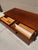 Florence Knoll-designed rosewood credenza with chrome legs and adjustable feet. This piece features a fully finished back...