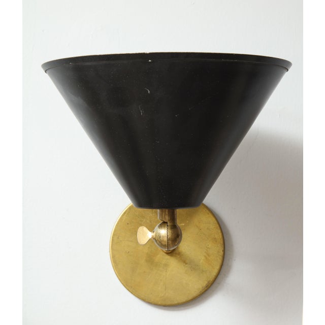 Pair of brass sconces inspired by midcentury design. Please note that black shade articulate. One pair in Stock Now. Size...