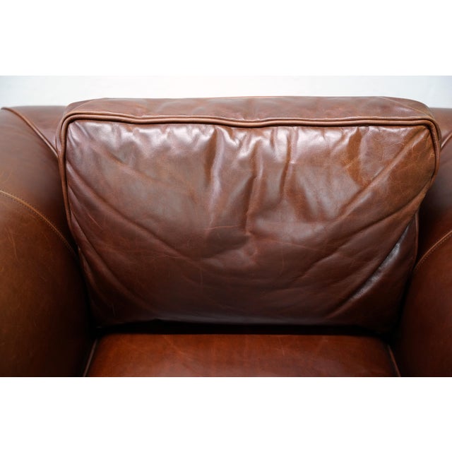 Luxurious Ralph Lauren leather British Colonial lounge chair with brass capped turned mahogany wood legs. The Regency...