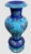A striking handcrafted decorative vase featuring authentic Lapis Lazuli, Turquoise, and warm golden inlay accents,...