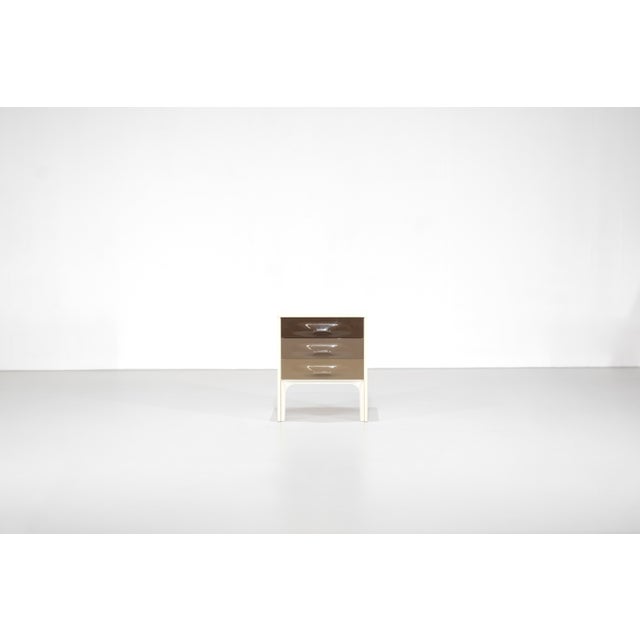 Bedside table or chest of drawers, model "DF 2000," featuring two molded plastic drawers with a color gradient from dark...