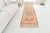 This is a vintage Turkish Oushak rug from the Mid 20th Century. The piece was hand-knotted.