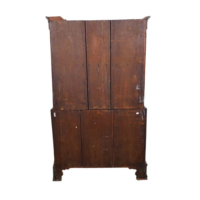 This 18th century English chest on chest with bracket feet and shell inlay is a solid oak piece featuring a brass handle...