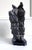 A Chinese scholar stone of Lingbi type presented on a carved wood base. This stone takes a singular vertical form with one...