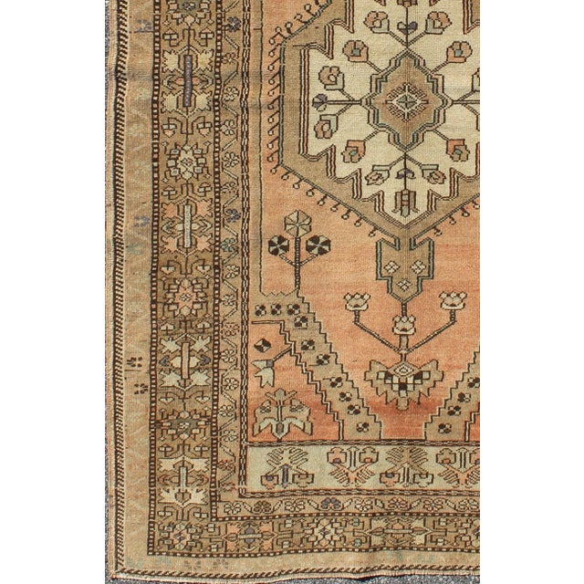 Measures: 4'7 x 7'10. Vintage Turkish Oushak Rug in Soft Apricot, Ivory, and Brown with Medallions. Keivan Woven Arts /...