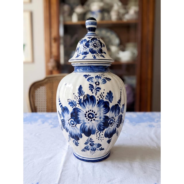 Elegant early 20th-century Dutch Delft Blue lidded vase, authentically made in Holland and hand-painted in the traditional...