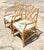 An exceptional pair of vintage Coastal rattan Chinese Chippendale armchairs, masterfully handcrafted with the timeless...