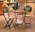 Charming and colorful, this antique French bistro set comprises a round folding table and two coordinating folding chairs....