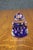 Handcrafted art glass paperweight featuring a rich cobalt blue interior encased in clear crystal with a ring of controlled...