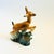 A mid century ceramic planter in the shape of a deer leaping over grass. Finished in green and brown glossy glazes. Plants...
