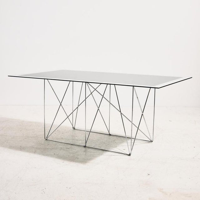 This French dining table was designed by Max Sauze in the 1970s. The table features clean lines, a glass top in black and...