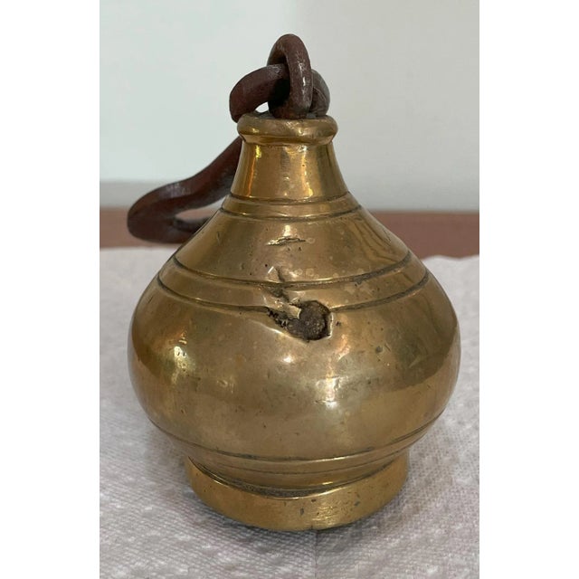 A 4 1/2 pound antique weight for a hanging scale.