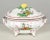 An early 20th century French faience footed oval tureen with traditional design typical of Eastern France. Hand-painted...