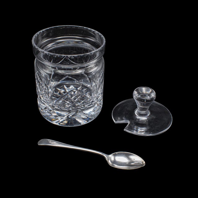 This is a vintage jam jar. An English, cut glass preserve or condiment pot with silver plated spoon, dating to the mid...