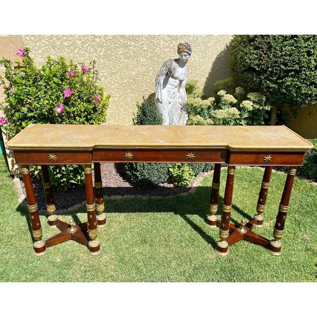 Rare and superb Empire style mahogany console table decorated with gilded bronzes. It is topped with an original Siena...