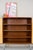 A beautiful walnut cabinet with clean lines and a warm, finely grained surface. The vertical grain extends across the two...